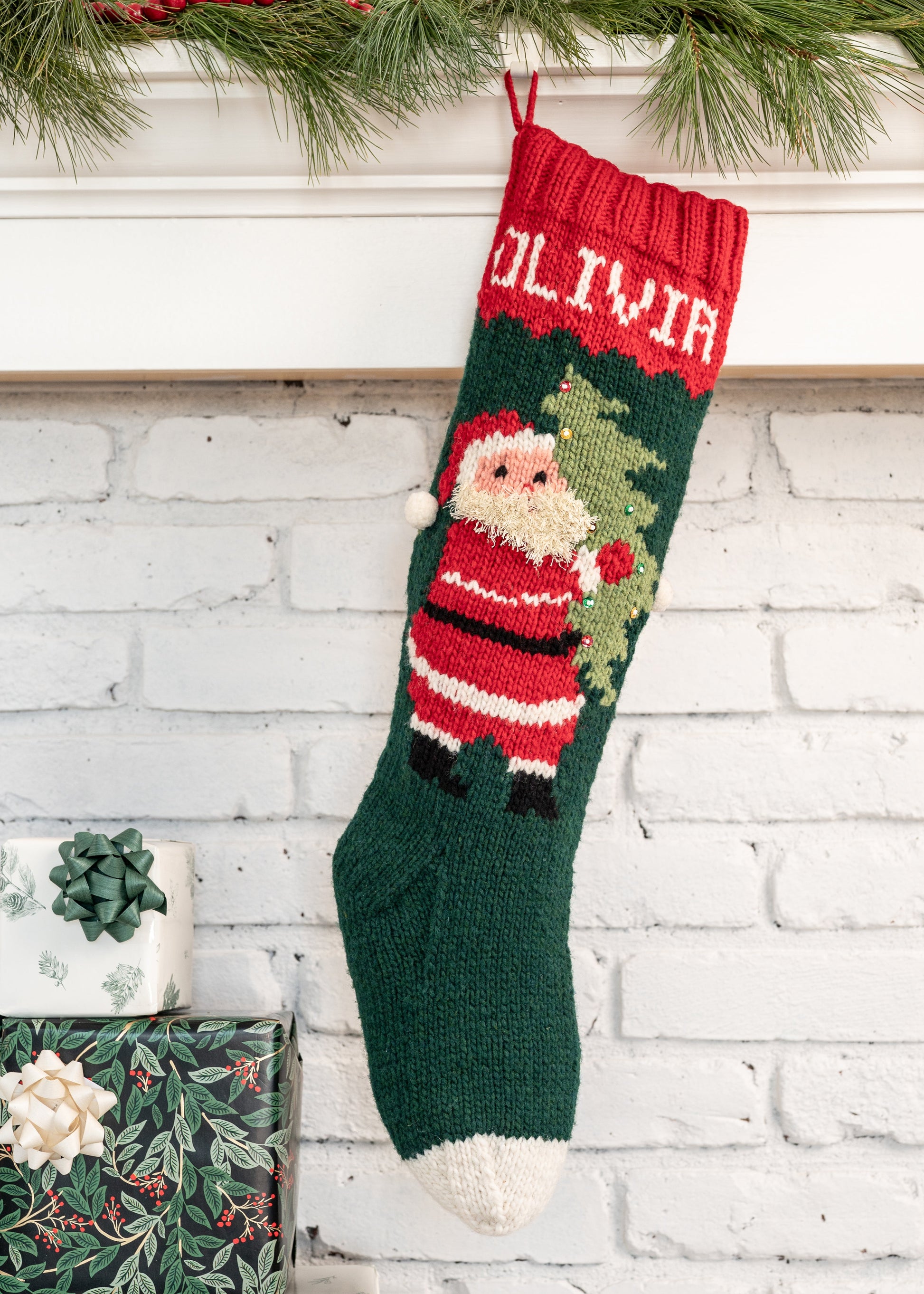 Christmas stocking knitting kit featuring Santa carrying a tree