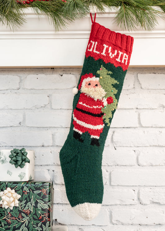 Christmas stocking knitting kit featuring Santa carrying a tree