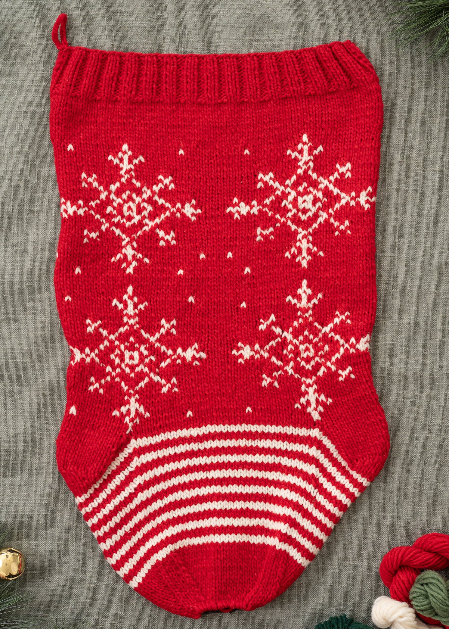 red Christmas stocking knitting kit with white snowflake design flat